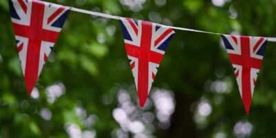 a british flag bunting on a tree line